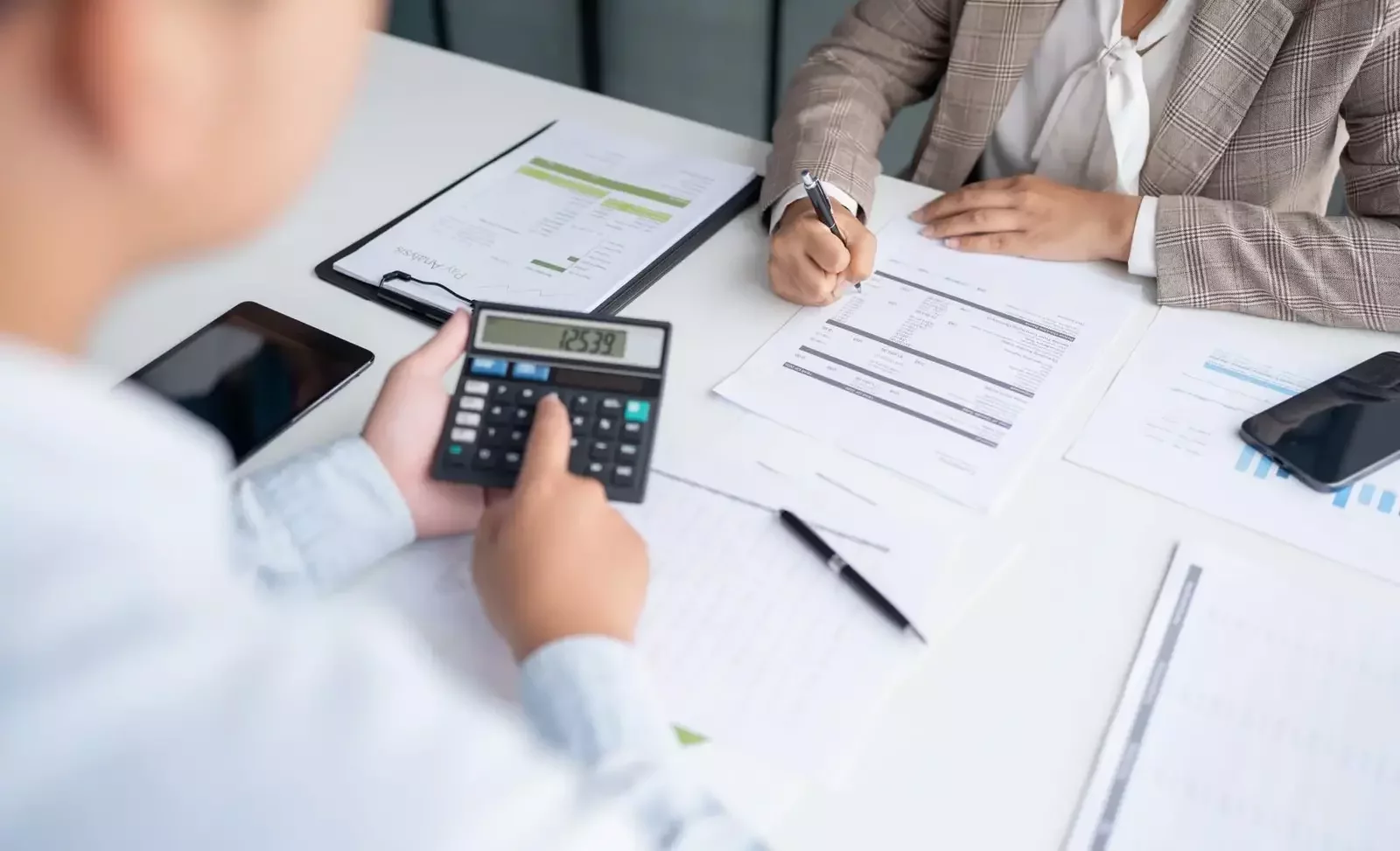  Professional accountants reviewing financial reports and tax documents during an accounting consultation session