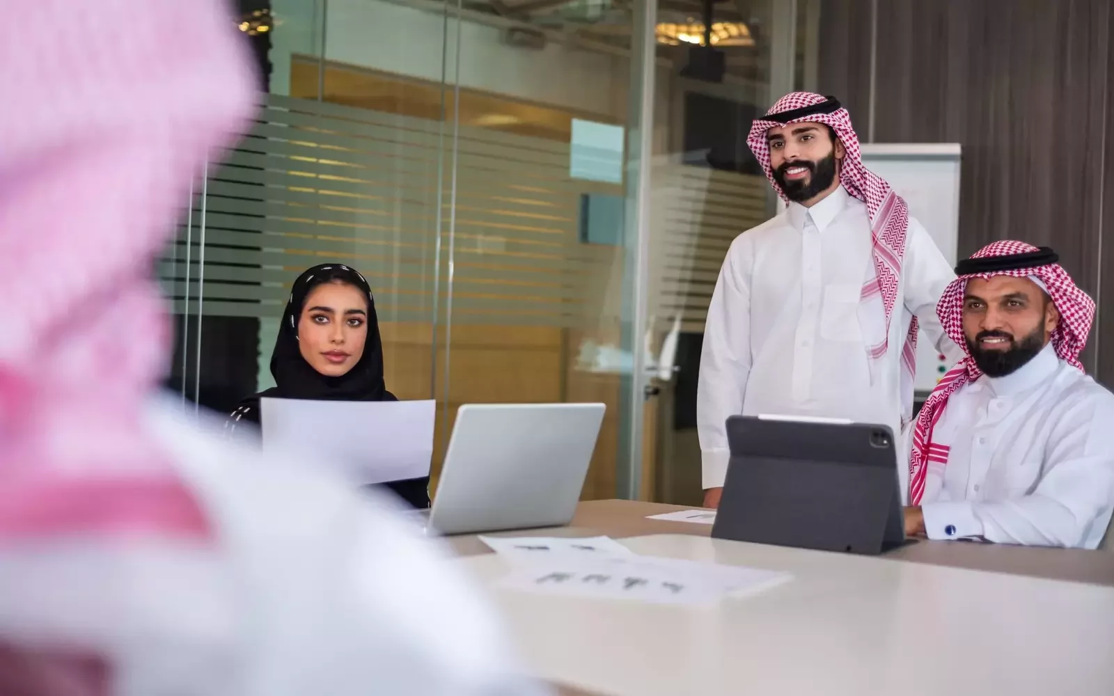 Professional Saudi accounting team collaborating in a business meeting at an accounting firm in Riyadh